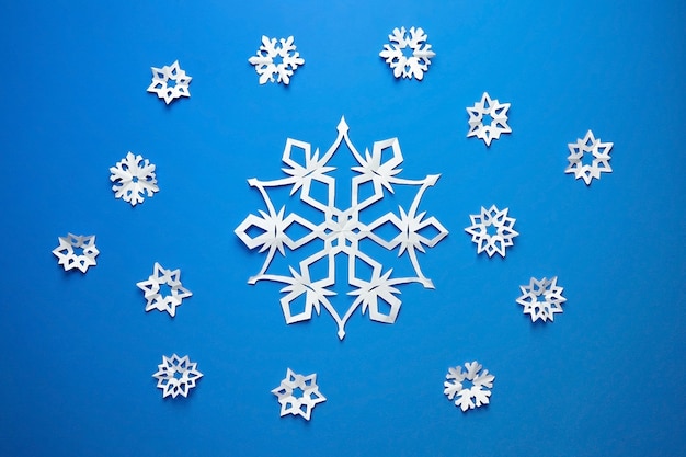 Composition with paper snowflakes on blue