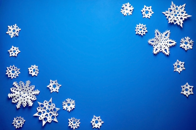 Composition with paper snowflakes on blue