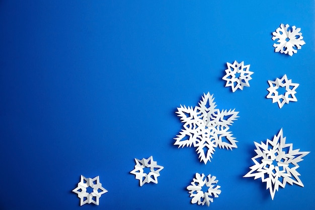 Composition with paper snowflakes on blue