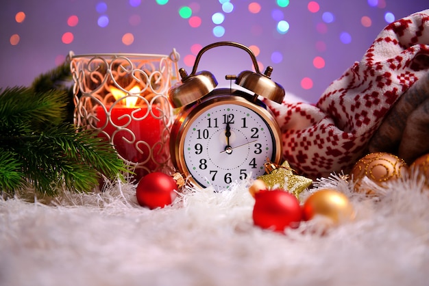 Composition with plaids, candles and Christmas decorations, on white carpet on bright background