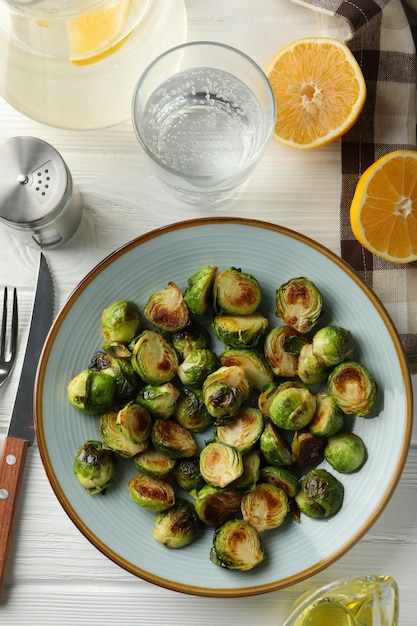 Composition with plate of brussels sprout on wooden surface