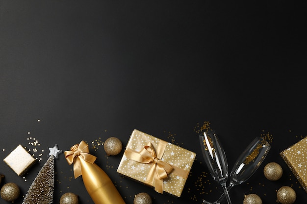 Composition with presents and christmas accessories on black table 