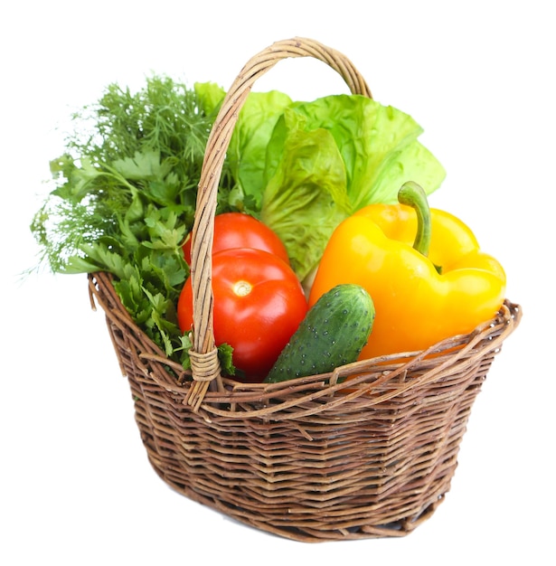 Composition with raw vegetables in wicker basket isolated on white