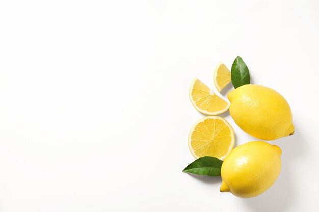 Composition with ripe lemons on white background