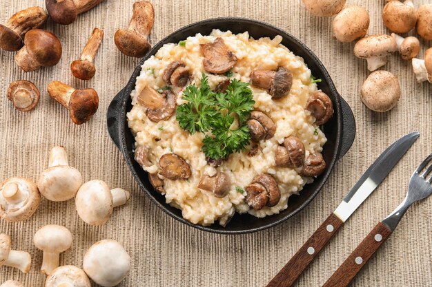 Photo composition with risotto and mushrooms on table top view