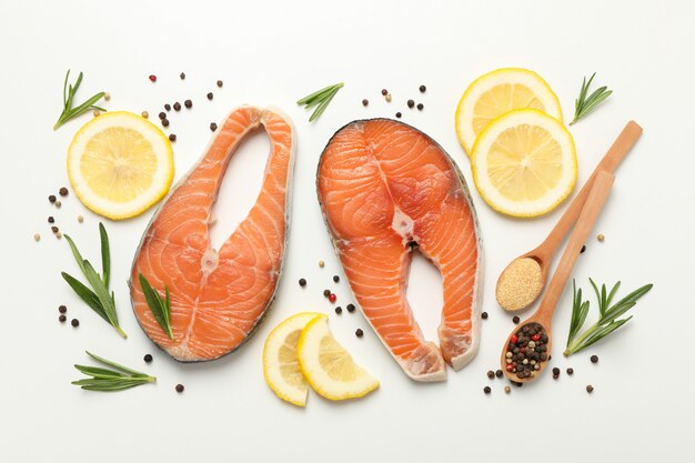 Composition with salmon meat and spices on white background, top view