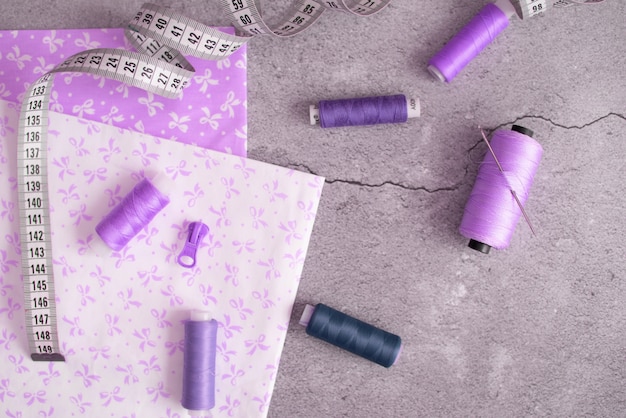 Composition with sewing threads and accessories on white background, top view