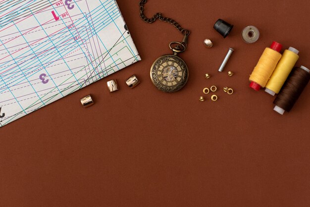 Composition with sewing threads and accessories on white background, top view