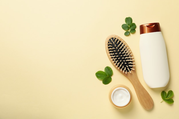 Photo composition with shampoo bottle on beige background, space for text