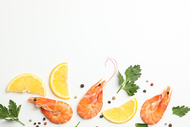 Photo composition with shrimps and spices on white background, top view