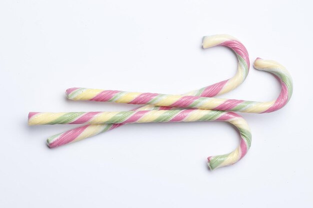 Composition with sweet candy cane  on color background. Top view. Place for text. Minimalism.