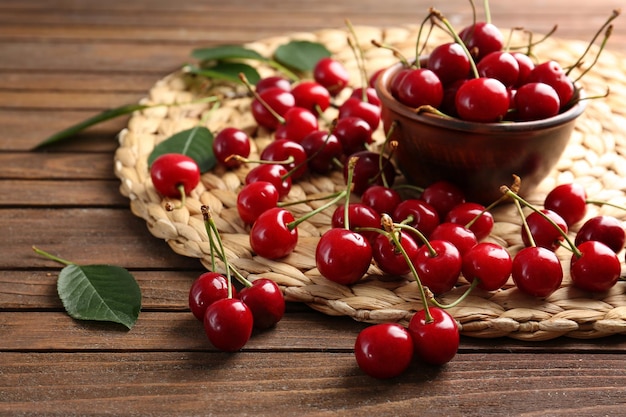 Composition with sweet ripe cherries and bowl on table