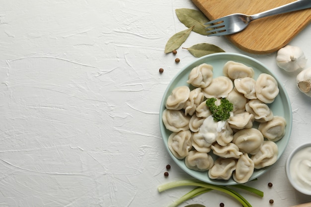 Composition with tasty dumplings on white background, space for text