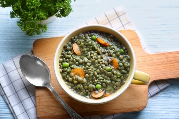 Composition with tasty lentil dish on wooden table