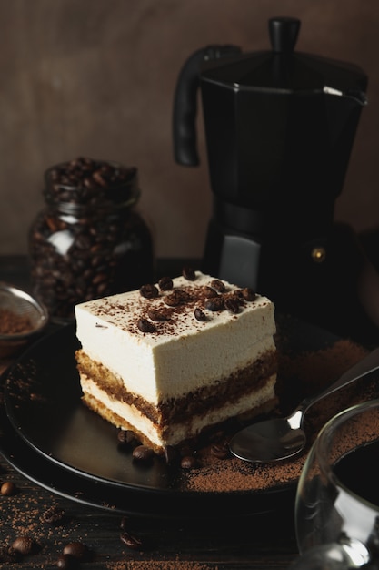 Composition with tasty tiramisu and coffee on wooden background