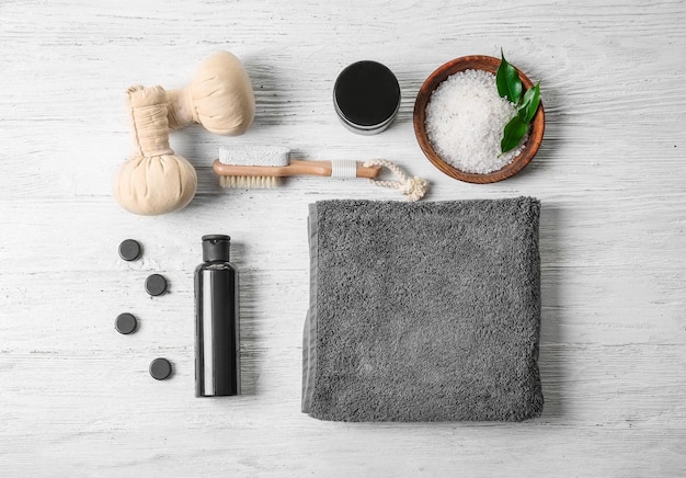 composition with towel and bath accessories on wooden background