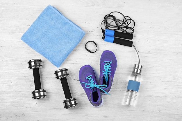 Composition with towel and sport equipment on wooden background