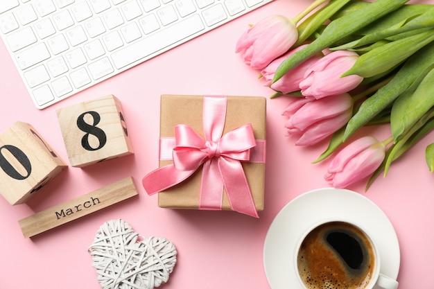 Photo composition with tulips and gift on pink, top view