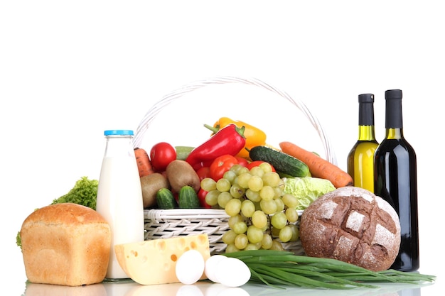 Photo composition with vegetables and fruits in wicker basket isolated on white