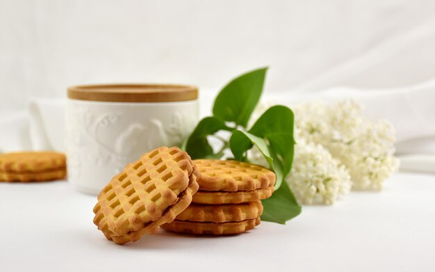 Composition with white liliac and cookies