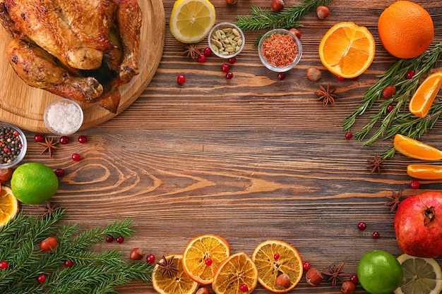 Composition with whole roasted turkey and some products on wooden surface