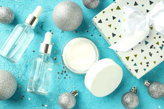 Composition with winter cosmetic products on blue textured background