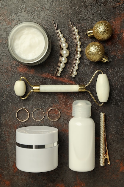 Composition with winter cosmetic products on textured background, top view