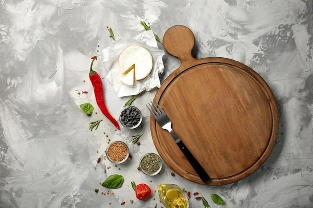 Composition with wooden board and ingredients for cooking on table