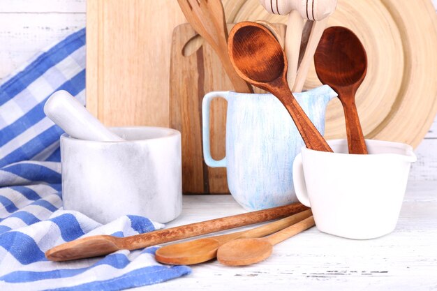 Photo composition of wooden cutlery mortar bowl and cutting board on wooden background