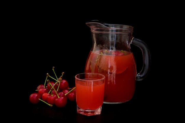 Compote with cherries and mint on a black background