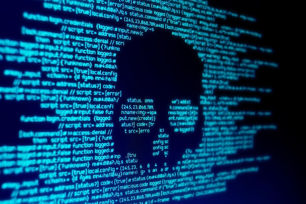 computer code on a screen with a skull representing a computer virus malware attack