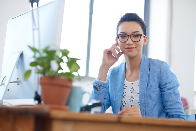 computer confident and portrait of woman by desk for digital communication website and research writer smile and employee with monitor in office for copywriting schedule and creative career