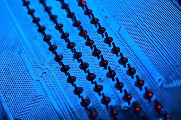 Фото Чип процессора процессора компьютера на фоне материнской платы крупным планом с красно-синим освещением