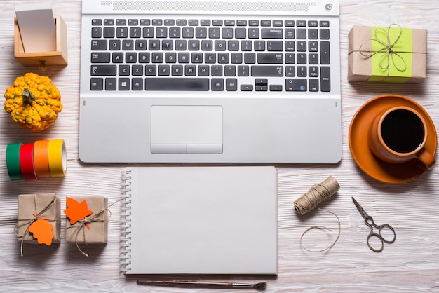 Computer and crafting tools on wood desk