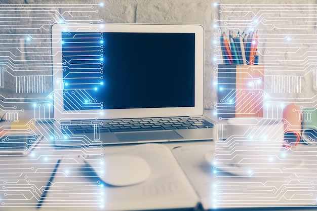 computer on desktop in office with technology theme hologram double exposure tech concept