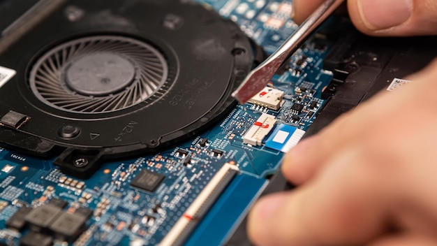 Computer engineer fixing broken laptop