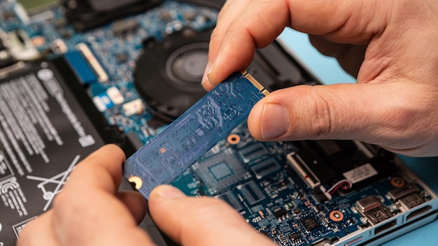 Computer engineer fixing broken laptop