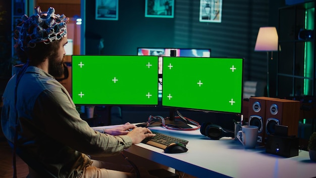 Computer engineer starting mind upload process using green screen PC
