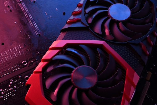 Computer game graphics card, videocard with two coolers on circuit board ,motherboard background. Close-up. With red-blue lighting.