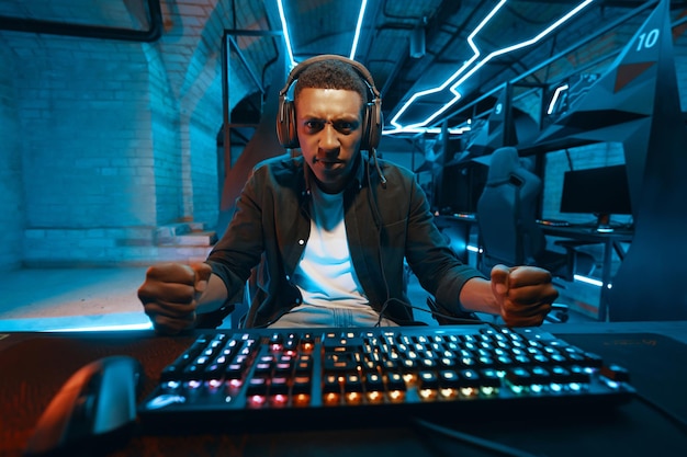 Computer gamer with hands on keyboard very emotional and surprised high quality photo