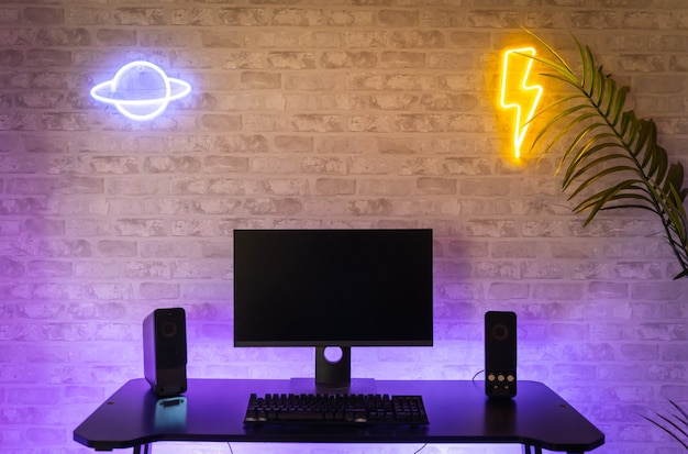 Computer gamer workspace with black screen monitor with neons and colorful lights Gamer Rig