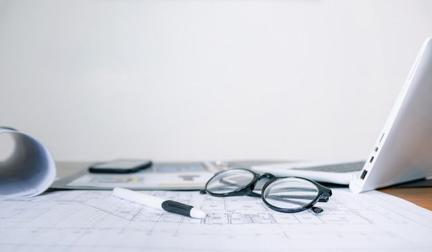 Computer glasses and documents on the desk in the office