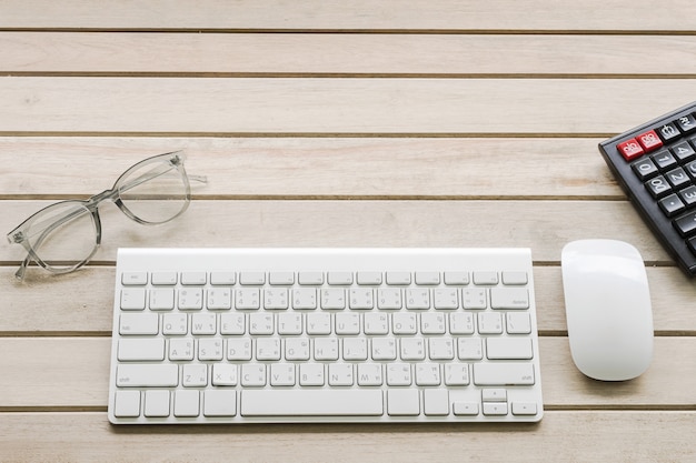 computer keyboard and mouse on wooden background