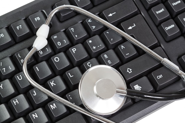 Computer Keyboard for PC and stethoscope as a diagnostic. Close-up.