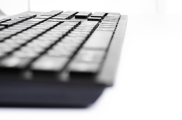 Computer keyboard on a white background Closeup Selective focus Side view