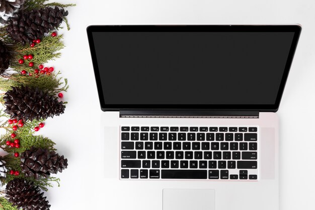 Computer laptop mobile display on table with isolated white screen for mockup in Christmas time