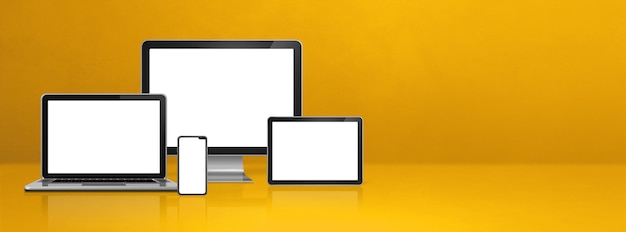 Computer, laptop, mobile phone and digital tablet pc - yellow office desk banner.