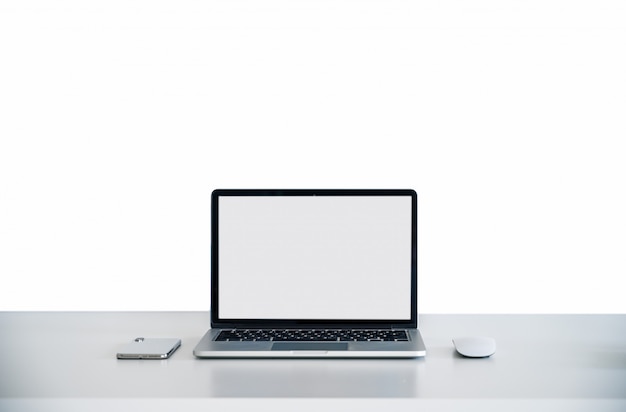 Computer laptop on the white table with White screen