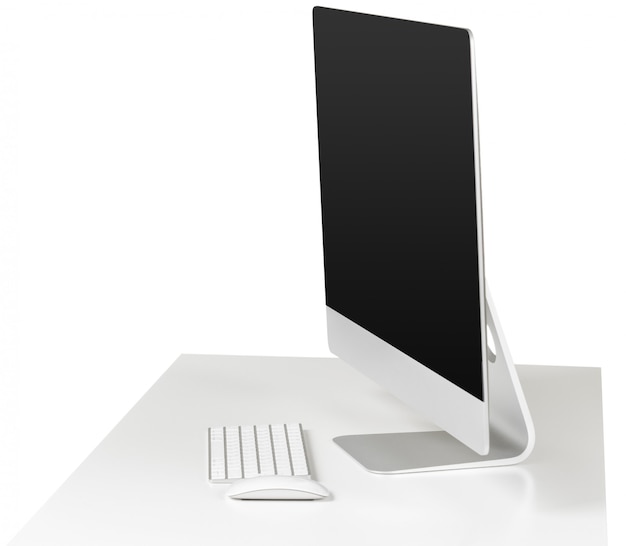 Computer monitor and keyboard on white table isolated on white background