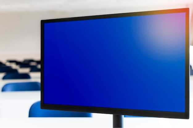 Computer monitor with blue screen empty classroom in the background Distance education concept